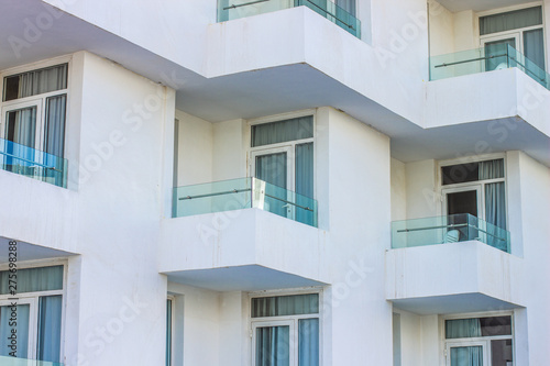 living house building background of geometric shape white concrete wall with balcony and windows 