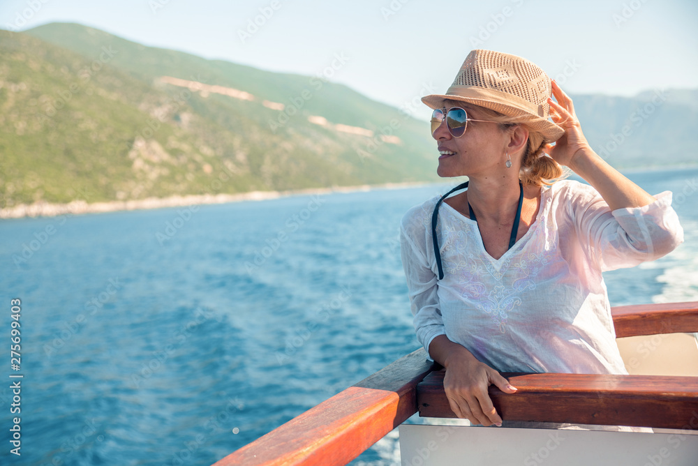 Happy woman enjoys the beach on a sunny day