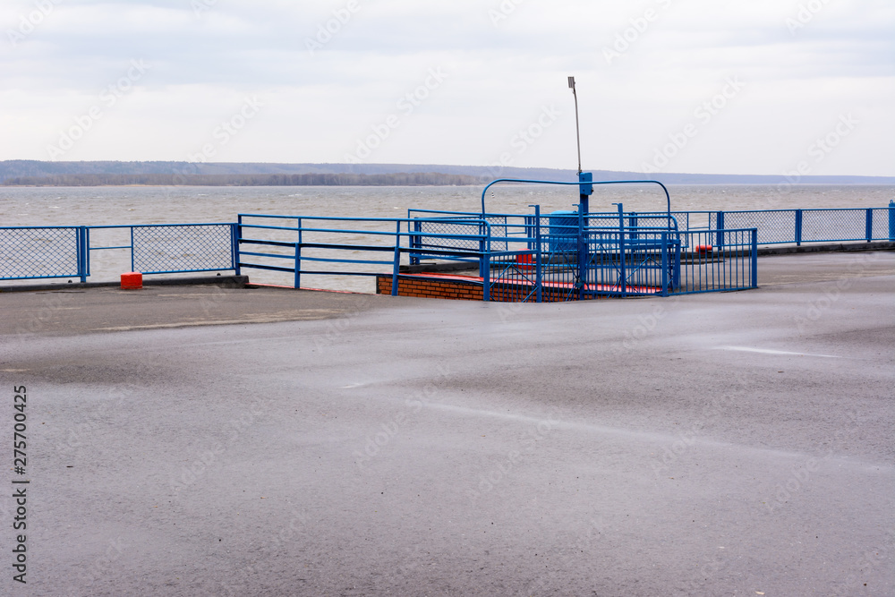 Tetyushi, Tatarstan / Russia - May 2, 2019: Empty passenger river port on the Volga River on a rainy day. Problems of the inland navigation.