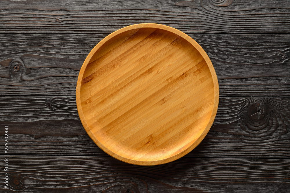 bamboo plate on wooden background top view bamboo plate on wooden background top view