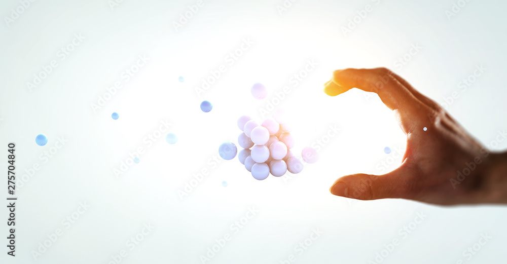 Woman hand and a bunch of spheres levitating above. Mixed media Woman hand and a bunch of spheres levitating above. Mixed media
