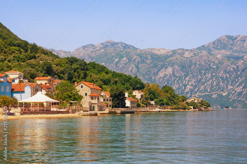 Summer landscape with sea, mountains and small seaside town. Montenegro, Adriatic Sea, Bay of Kotor, Prcanj