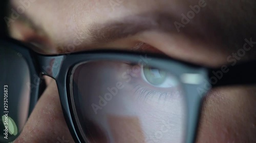 Wallpaper Mural Woman in glasses looking on the monitor and surfing Internet. The monitor screen is reflected in the glasses Torontodigital.ca