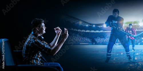 Young man watching ice hockey game on TV