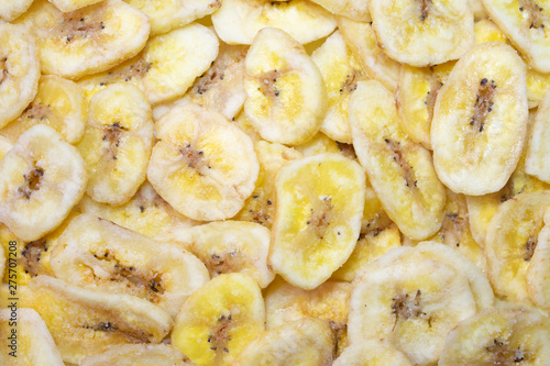 Background made of many dehydrated banana pieces, dried banana chips