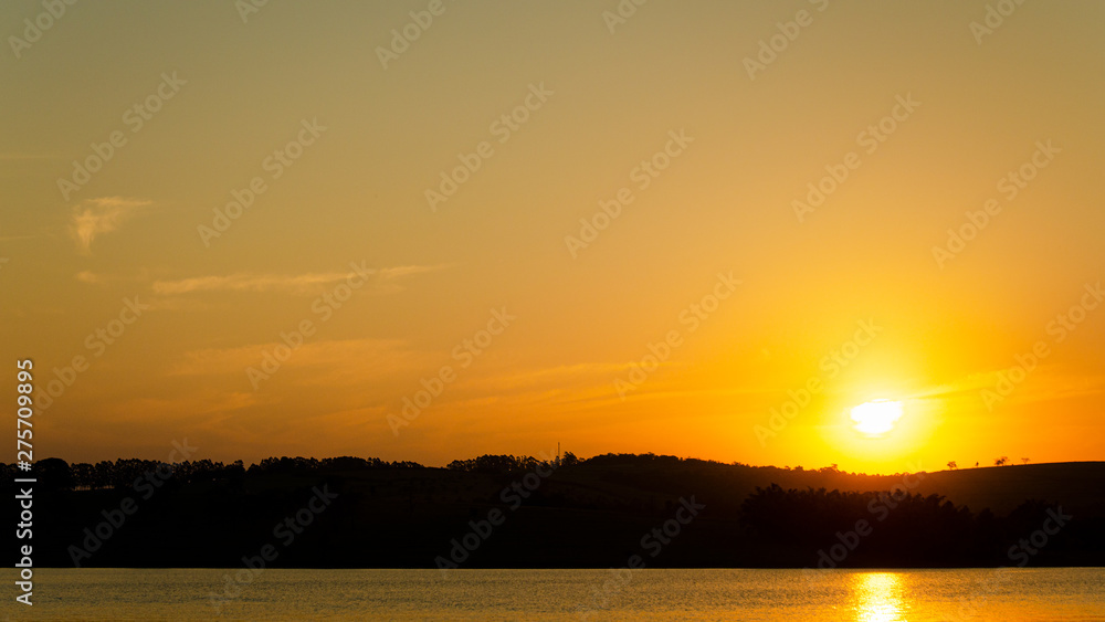 Background image landscape photography of beautiful orange sunset landscape over the mountain and lake in the afternoon