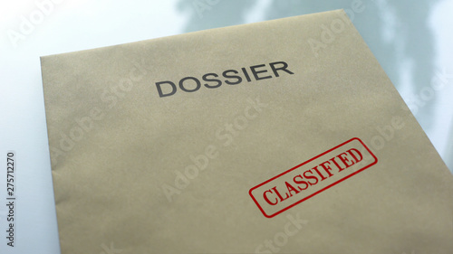 Dossier classified, seal stamped on folder with important documents, close up photo