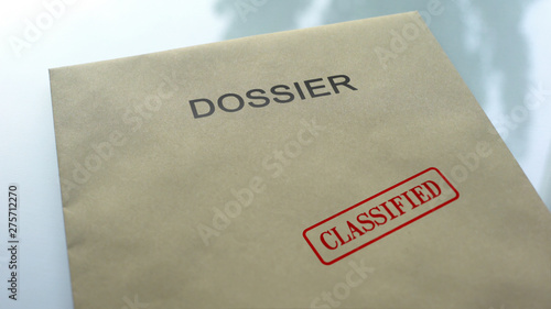Dossier classified, seal stamped on folder with important documents, close up