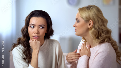 Φωτογραφία Young bored woman listening her annoying friend, uninvolved in conversation