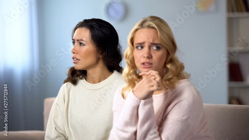 Worried woman being afraid to confess her friend, secret information, shame