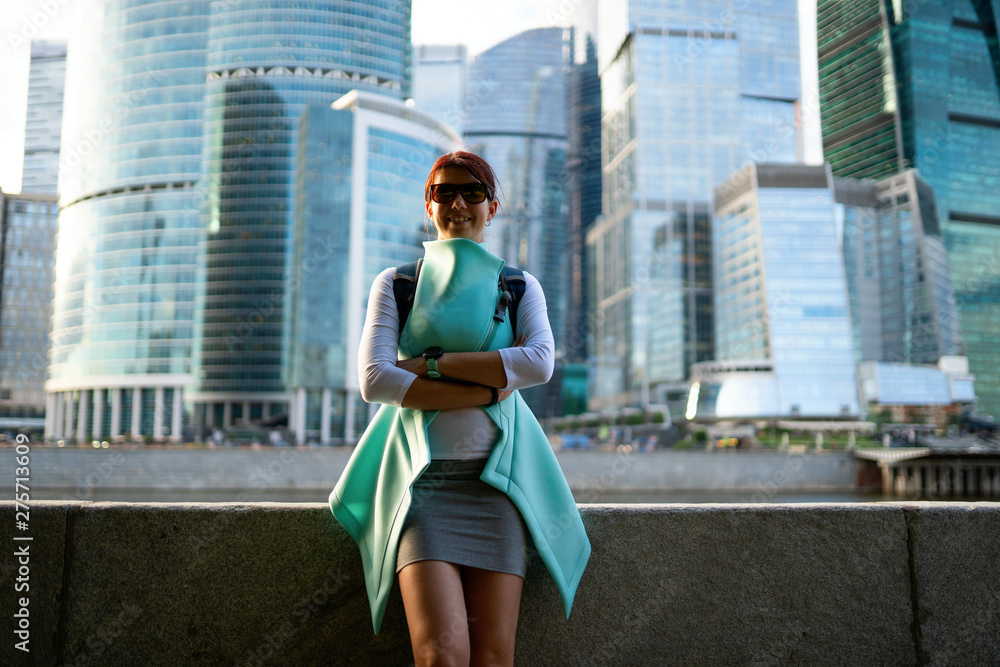 Portrait of young woman walking on the street, wearing cute trendy jacket.