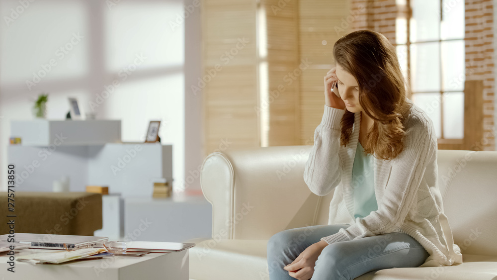 Serious woman talking on phone, calling to support service, problem with app Serious woman talking on phone, calling to support service, problem with app