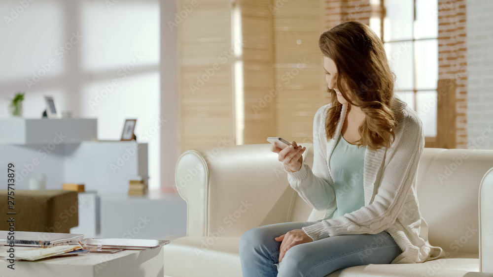 Happy woman reading message with good news, satisfied with app on cellphone Happy woman reading message with good news, satisfied with app on cellphone