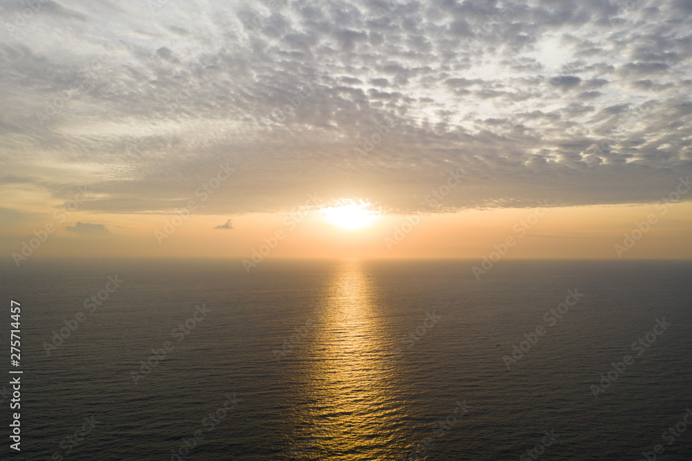 Aerial drone view of sea and amazing sunset with cloudy sky