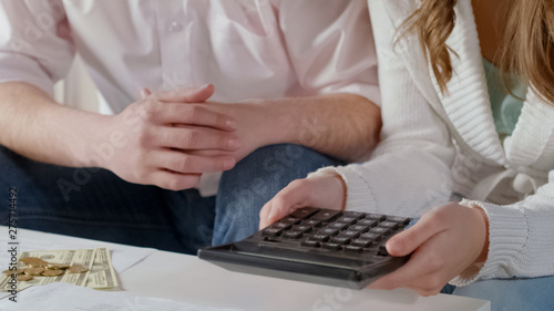Middle-class couple calculating monthly payments, low family budget, bankruptcy
