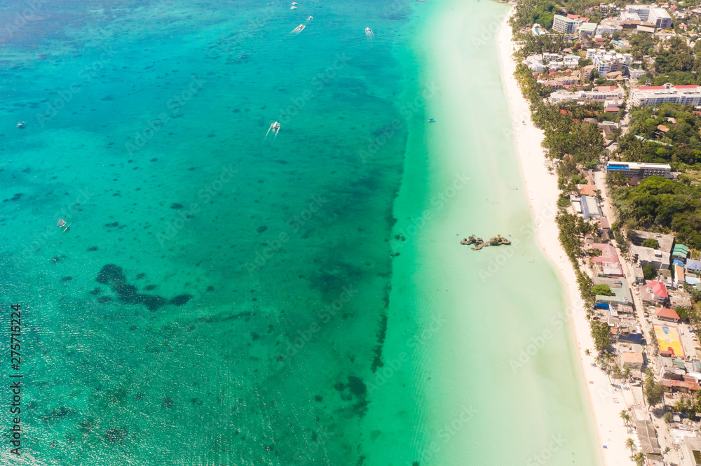 Beautiful lagoon with boats and tourist beach. White beach on the island of Boracay, top view. Seascape in sunny weather.