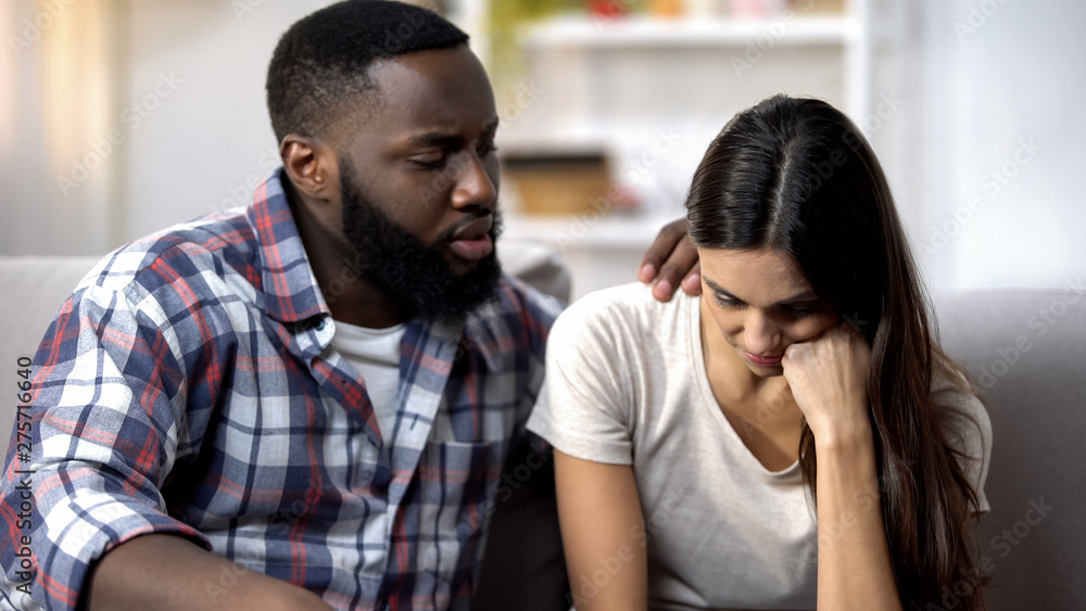 African-American man consoling upset wife, health and life problems, support African-American man consoling upset wife, health and life problems, support