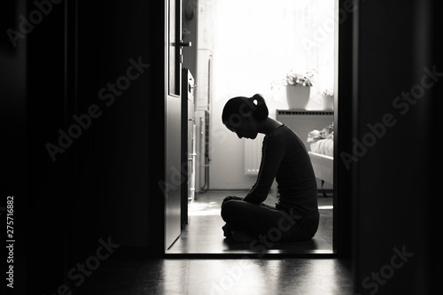Photography Young sad emotional woman sitting alone.