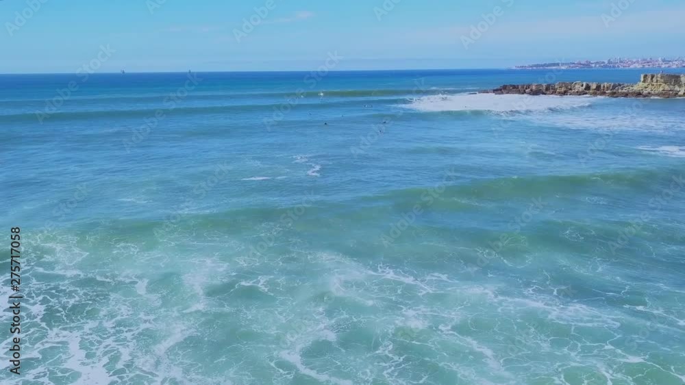 Aerial View of Atlantic coast and surfers in water an on the waves in Cascais, Portugal. Clifs coast and sea Aerial View of Atlantic coast and surfers in water an on the waves in Cascais, Portugal. Clifs coast and sea