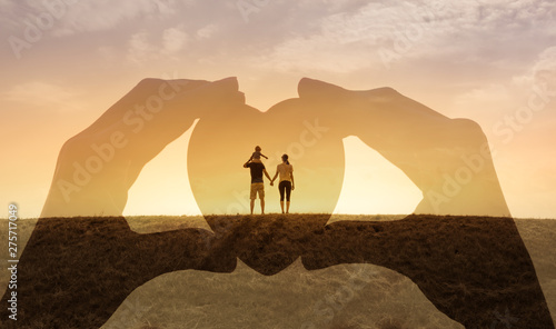 Happy loving family concept. Mother father child standing together watching the sunset.  Double exposure