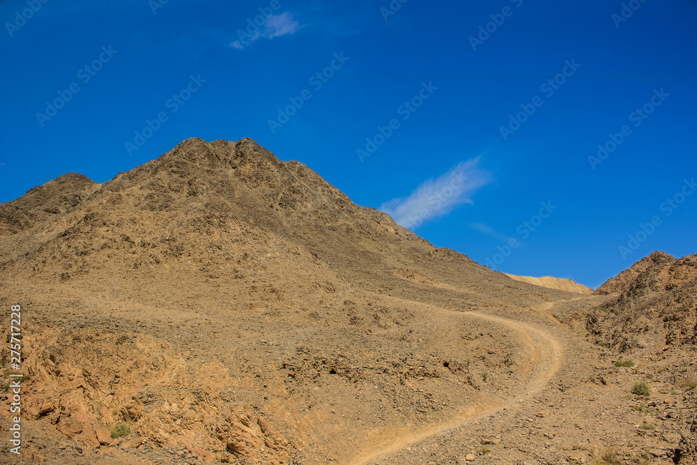 Asian picturesque scenery landscape national park photography of desert rocky mountains wilderness wasteland environment with lonely trail for hiking on vivid blue sky background 