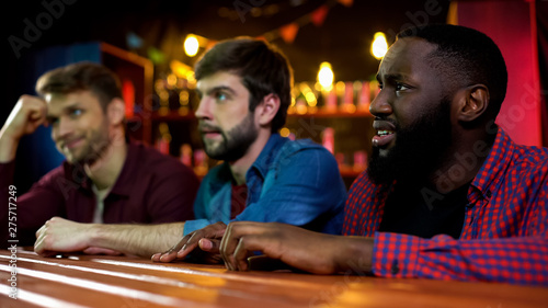 Emotional multiracial friends unhappy, national team losing match, time in pub