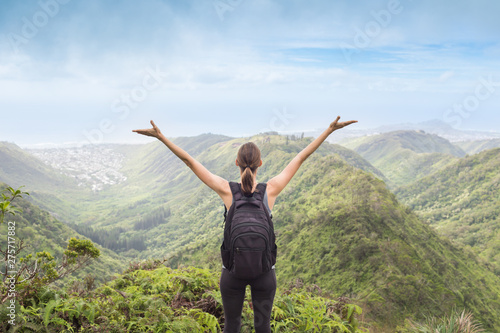 Female hiker celebrating her climb to the top of mountain. Location Hawaii © kieferpix