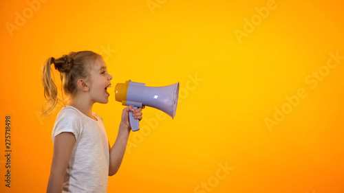 Schoolgirl shouting in megaphone, making announcement, sales and discounts