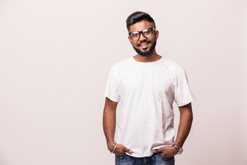 Young indian handsome man in eyesglasses standing isolated on white background