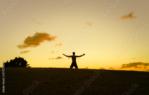 Young man wit arms outstretched in a beautiful nature setting. Getting away from it all. 