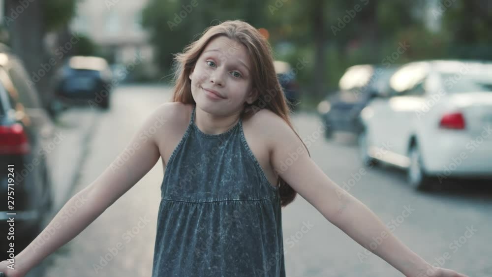 Nice surprised girl standing in road and shrugging. Close-up footage of pretty teenager in romantic sundress. Autos. Summertime. Outdoors, beautiful, lovely, nice, cute, pretty Nice surprised girl standing in road and shrugging. Close-up footage of pretty teenager in romantic sundress. Autos. Summertime. Outdoors, beautiful, lovely, nice, cute, pretty
