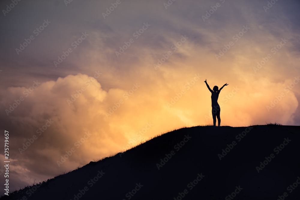 Woman reaching top of mountain. Triumph, victory and feeling determined.