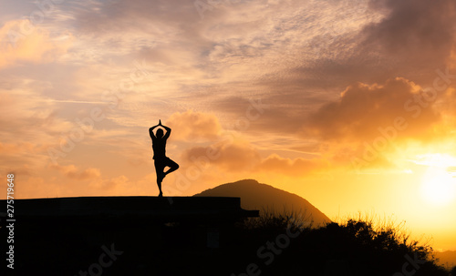 silhouette of man meditating at sunset