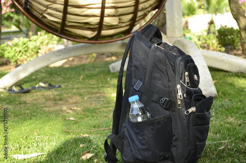 backpack with a bottle on the grass