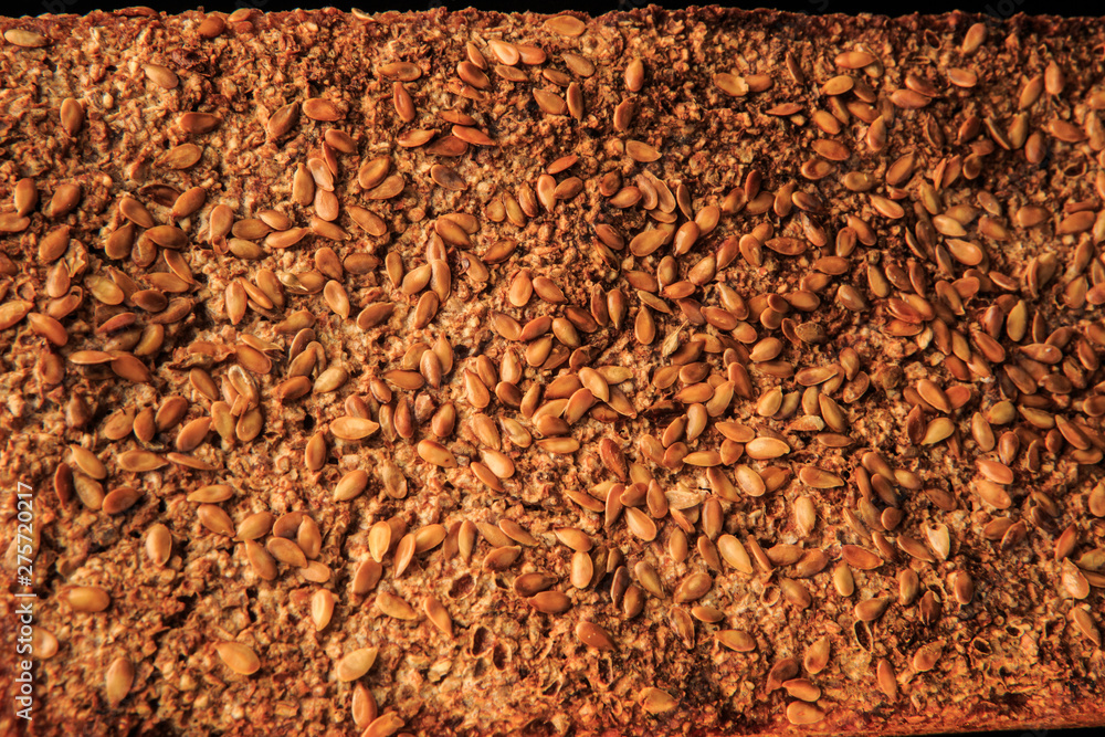 closeup surface of homemade whole rye bread with sesame seeds