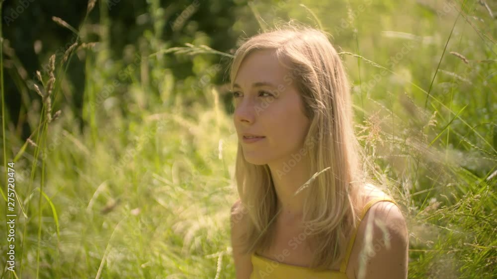Peaceful Woman Relaxing in the Grass in the Beautiful Sunny Outdoors Peaceful Woman Relaxing in the Grass in the Beautiful Sunny Outdoors