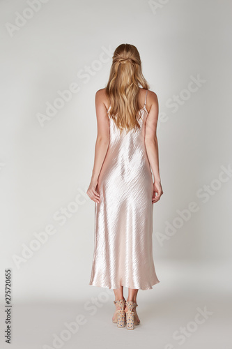 Pretty woman beautiful face bright makeup long blond hair fashion model wear trend clothes for date party summer walk travel cruise collection organic silk cotton dress accessory jewelry white studio.