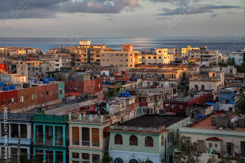 Aerial view of the residential homes in Havana City, Capital of Cuba, during a colorful cloudy sunrise.