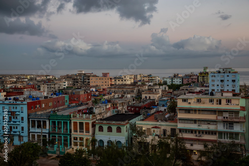 Aerial view of the residential homes in Havana City, Capital of Cuba, during a colorful cloudy sunrise. © edb3_16