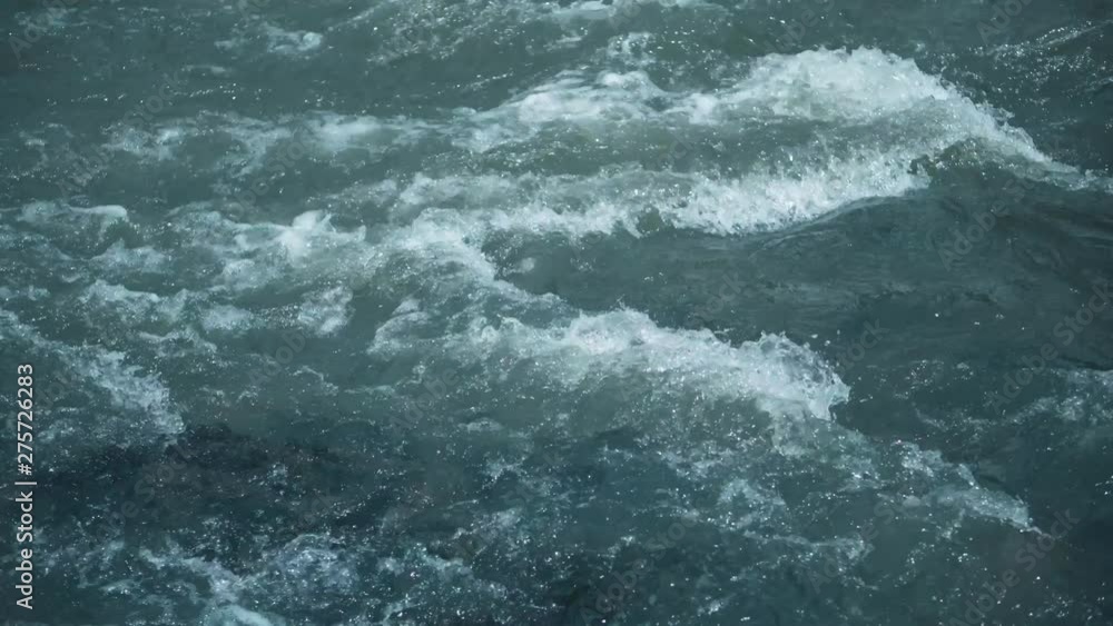 Mountain river water with fast closeup. Water beats on the stones. The rapid flow of the river on 4k video. Mountain river water with fast closeup. Water beats on the stones. The rapid flow of the river on 4k video.