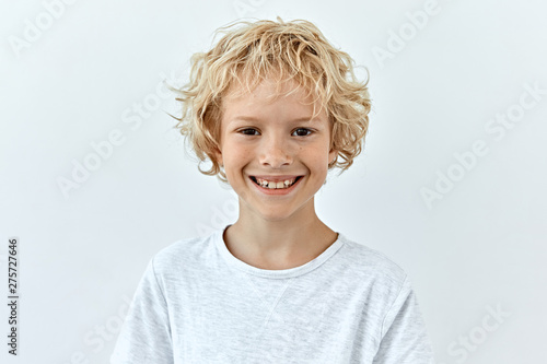 Little child boy portrait against white background. Laughter and joy emotions