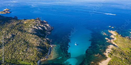 View from above, stunning aerial view of a sailing boat floating on a beautiful turquoise clear sea. Maddalena Archipelago National Park, Sardinia, Italy. © Travel Wild