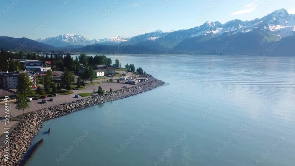 Drone aerial flight over the waterfront of Seward Alaska; visible in this shot are a calm Resurrection Bay, Kenai Mountains, Waterfront Park, campground, parking lots, campground, hotels, and homes Drone aerial flight over the waterfront of Seward Alaska; visible in this shot are a calm Resurrection Bay, Kenai Mountains, Waterfront Park, campground, parking lots, campground, hotels, and homes