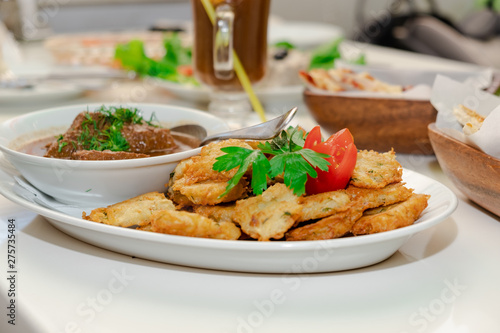 National Jewish dish - Fleish mit latex - beef stew with potato pancakes photo