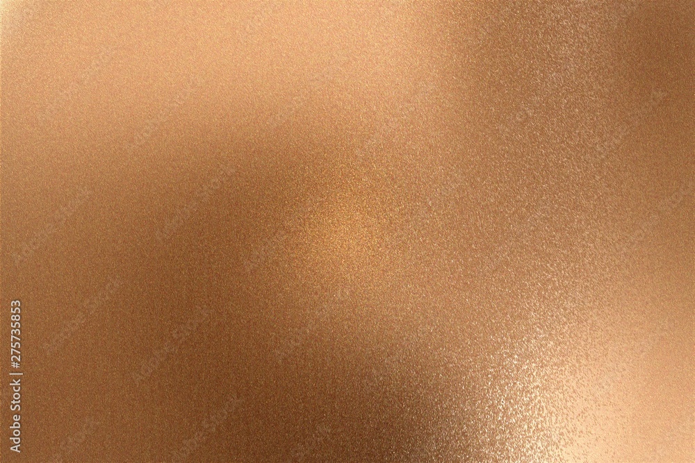 Glowing bronze metallic wall with scratched surface, abstract texture background