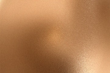 Glowing bronze metallic wall with scratched surface, abstract texture background