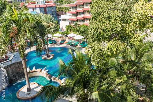 resting area in the tropical hotel  view from balcony. sun deck of resort. Swimming pool view and palm trees. take a rest time concept.