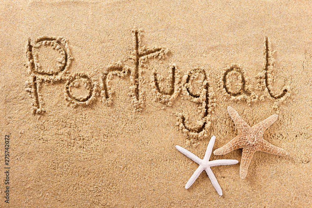 Portugal word written in sand on a sunny summer beach with starfish holiday vacation travel destination sign writing message photo - obrazy, fototapety, plakaty 