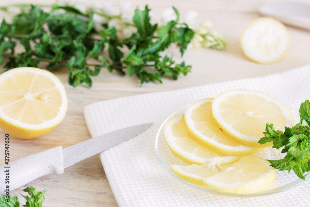 lemon is cut into slices, the process of cooking lemon dishes, juicy pieces of tropical fruits, dietary fruits, healthy foods, ingredients for cocktails lemon is cut into slices, the process of cooking lemon dishes, juicy pieces of tropical fruits, dietary fruits, healthy foods, ingredients for cocktails