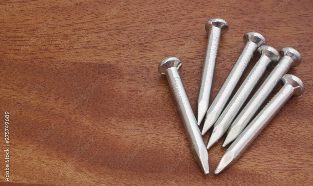 Group of nails on wooden board with room for text Group of nails on wooden board with room for text